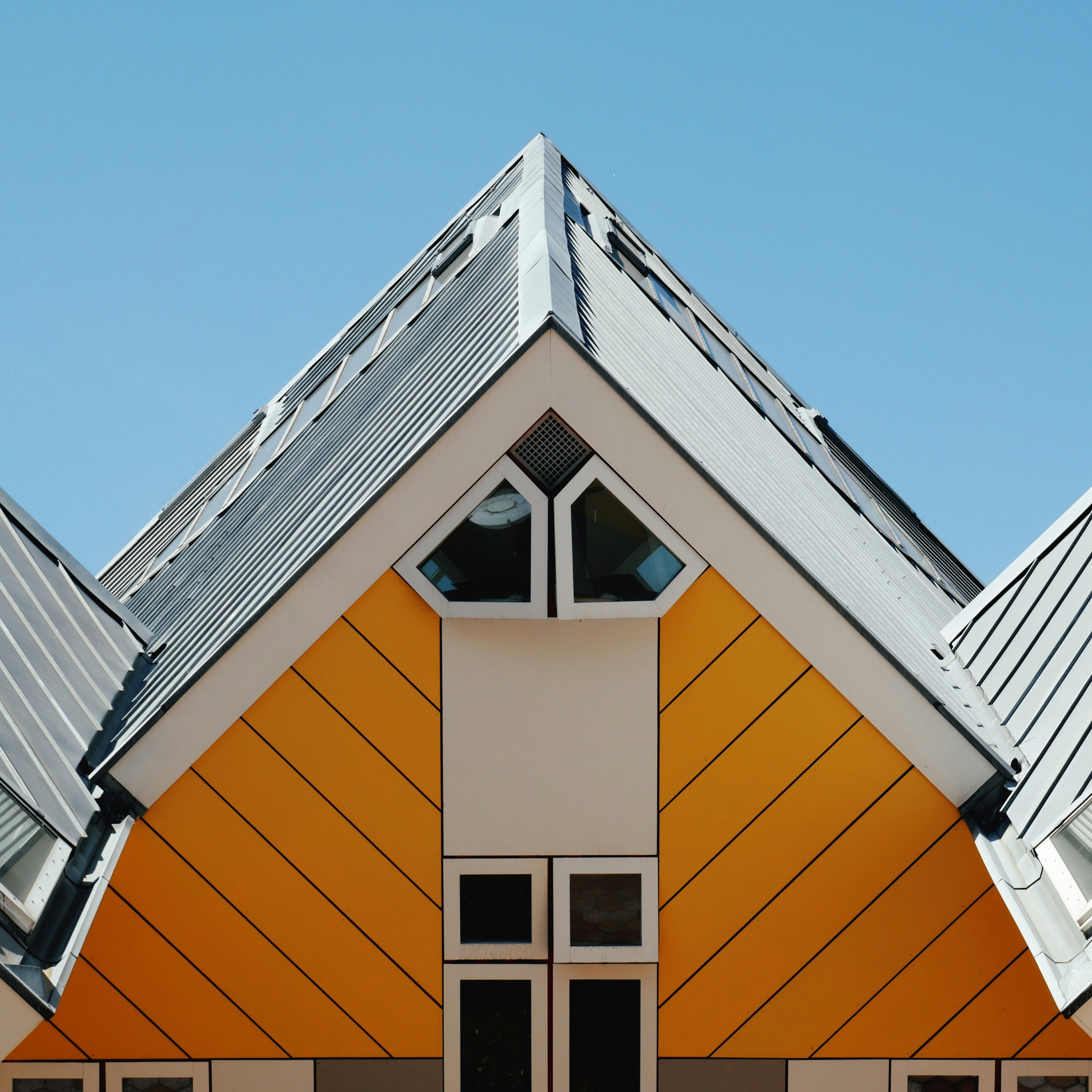 orange and white concrete house under blue sky during daytime